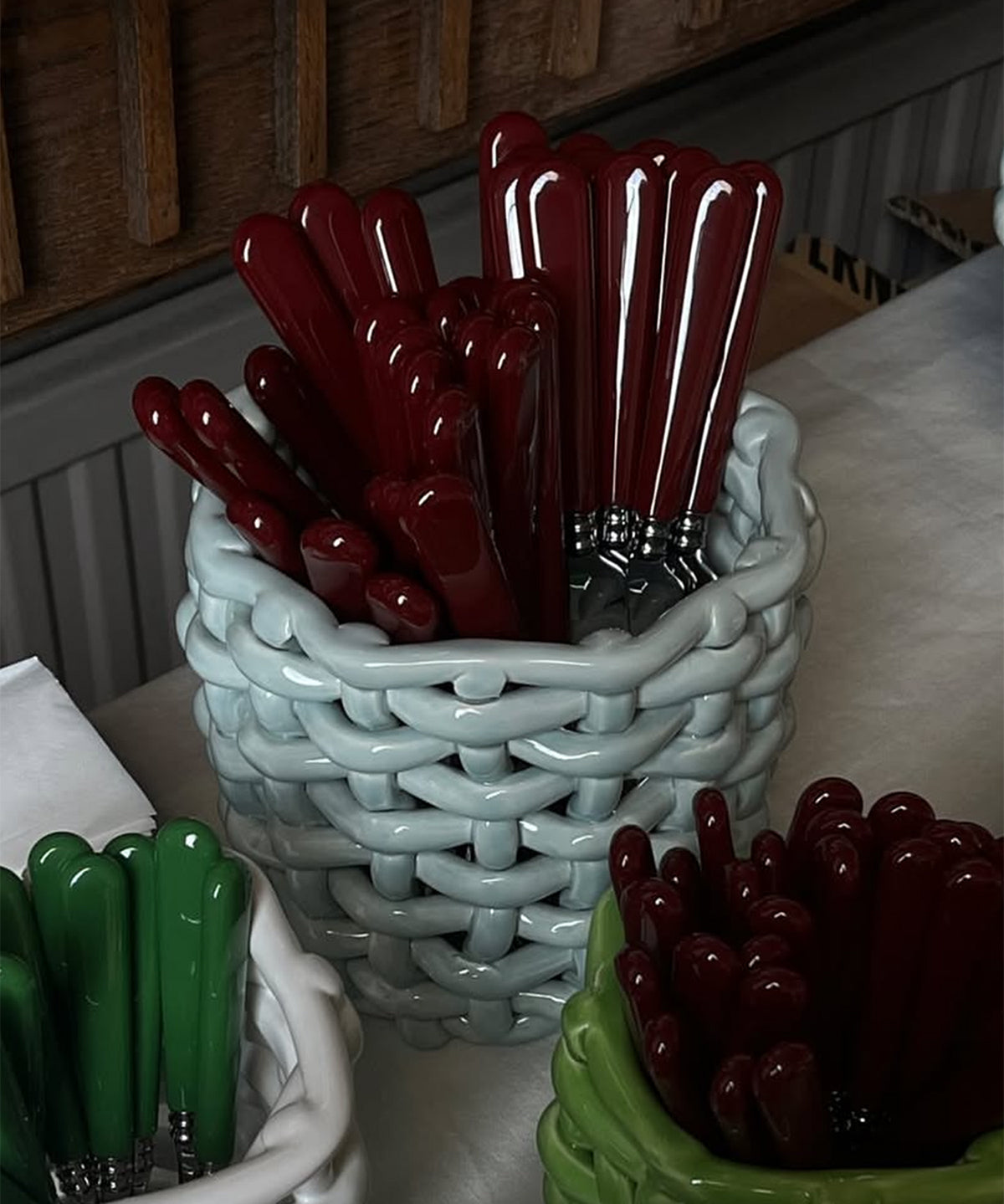 Baskets with red and green handles on a table