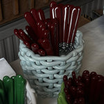 Baskets with red and green handles on a table