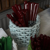 Baskets with red and green handles on a table