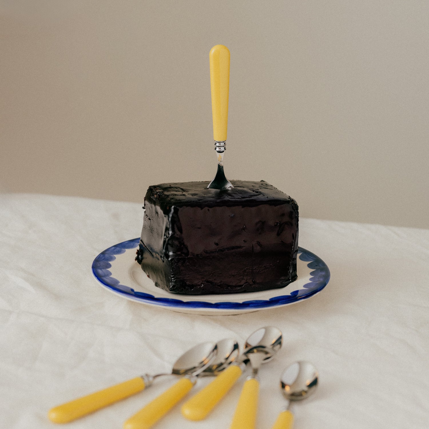 Blue scallop plate with yellow teaspoon