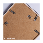 Back of a frame with metal brackets and cork surface, labeled A3/A2 frame back.