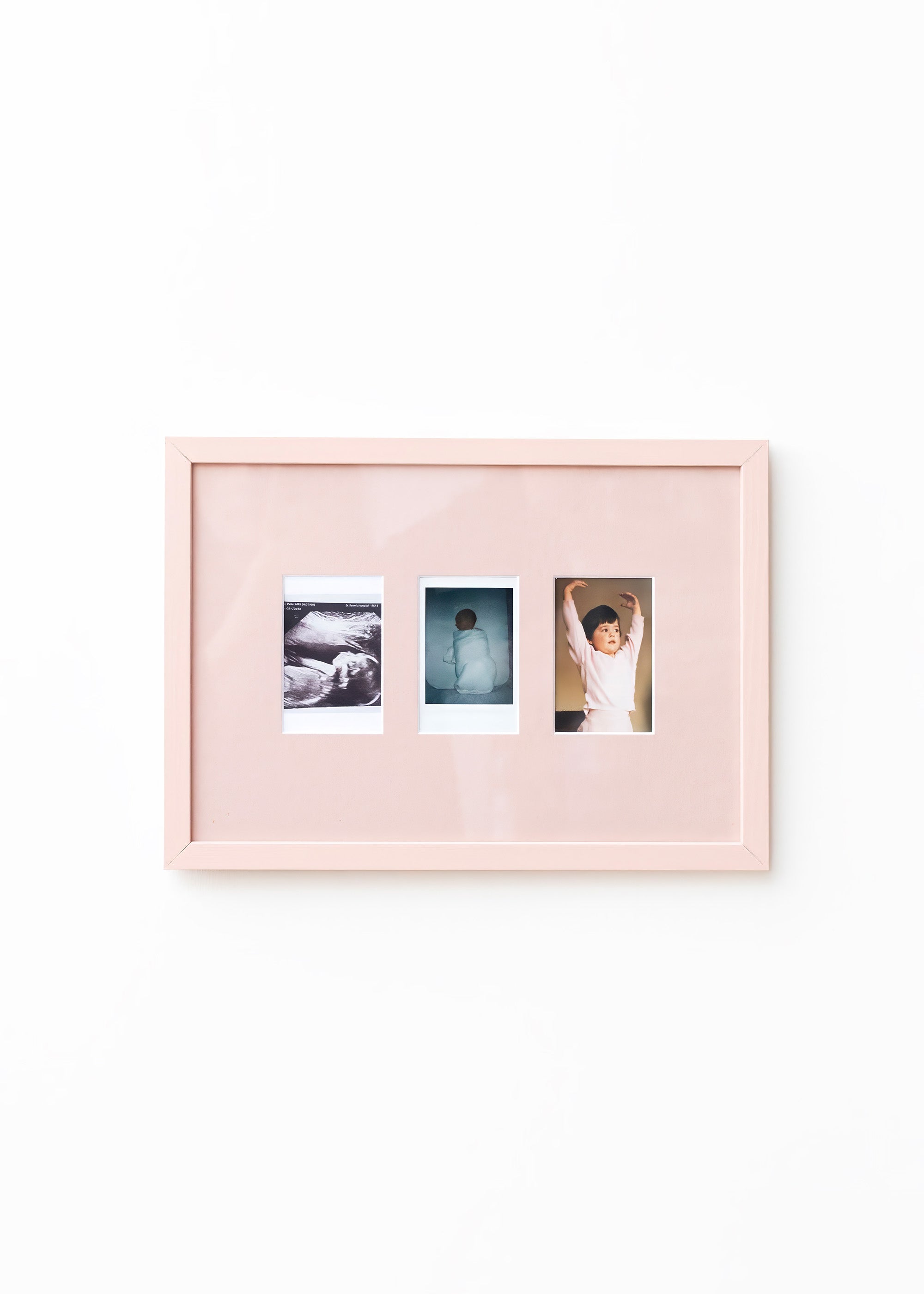 A light pink double-photo frame with a glossy finish, displaying two sample photographs side-by-side against a clean white background.