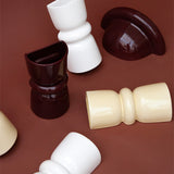 Late Afternoon Lighting Collection of Up and Down lighter Ceramic Sconce Wall Lights on a brown background