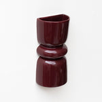 Late Afternoon Lighting Burgundy Up and Down lighter Ceramic Wall Light hung on a white wall
