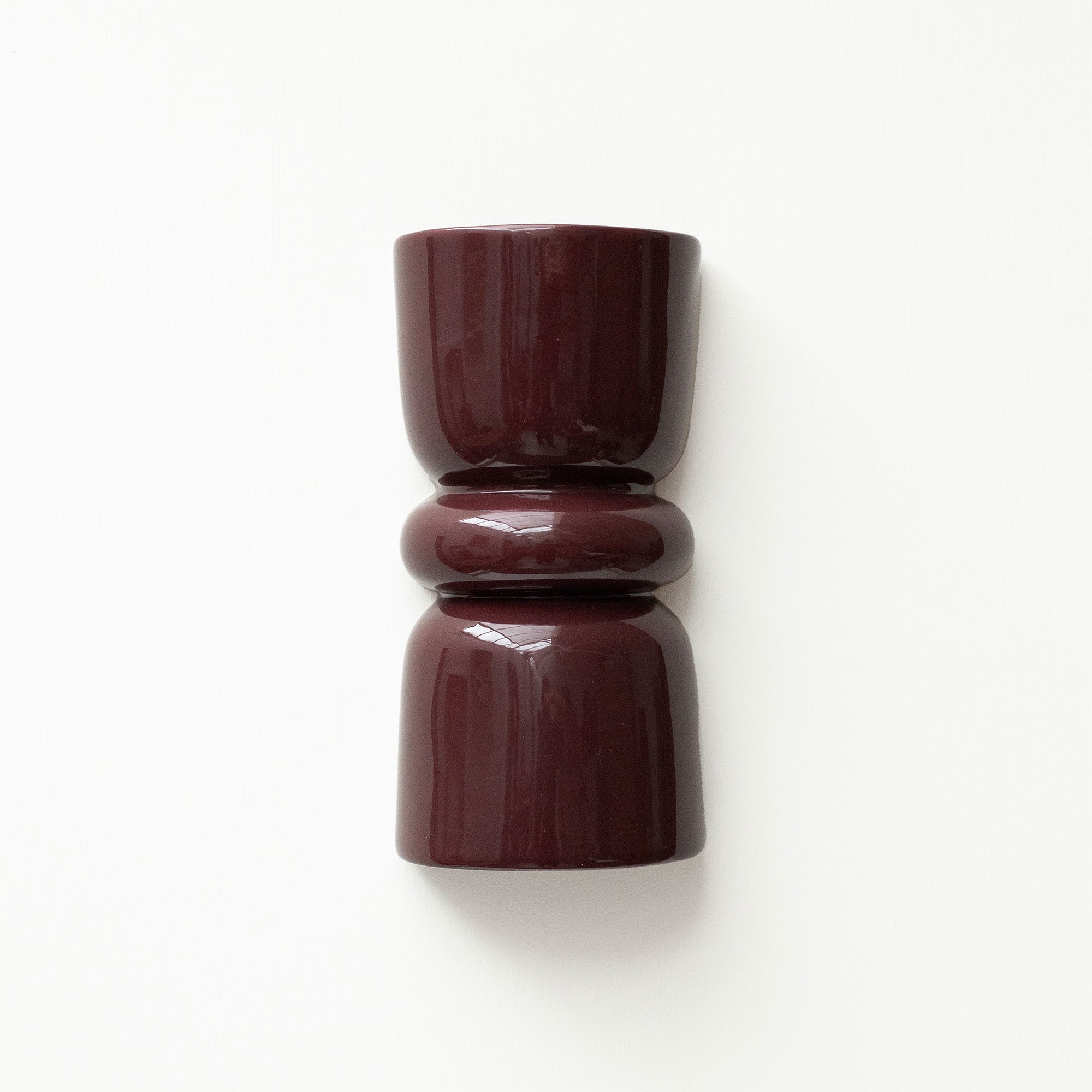 Late Afternoon Lighting Burgundy Up and Down lighter Ceramic Wall Light hung on a white wall