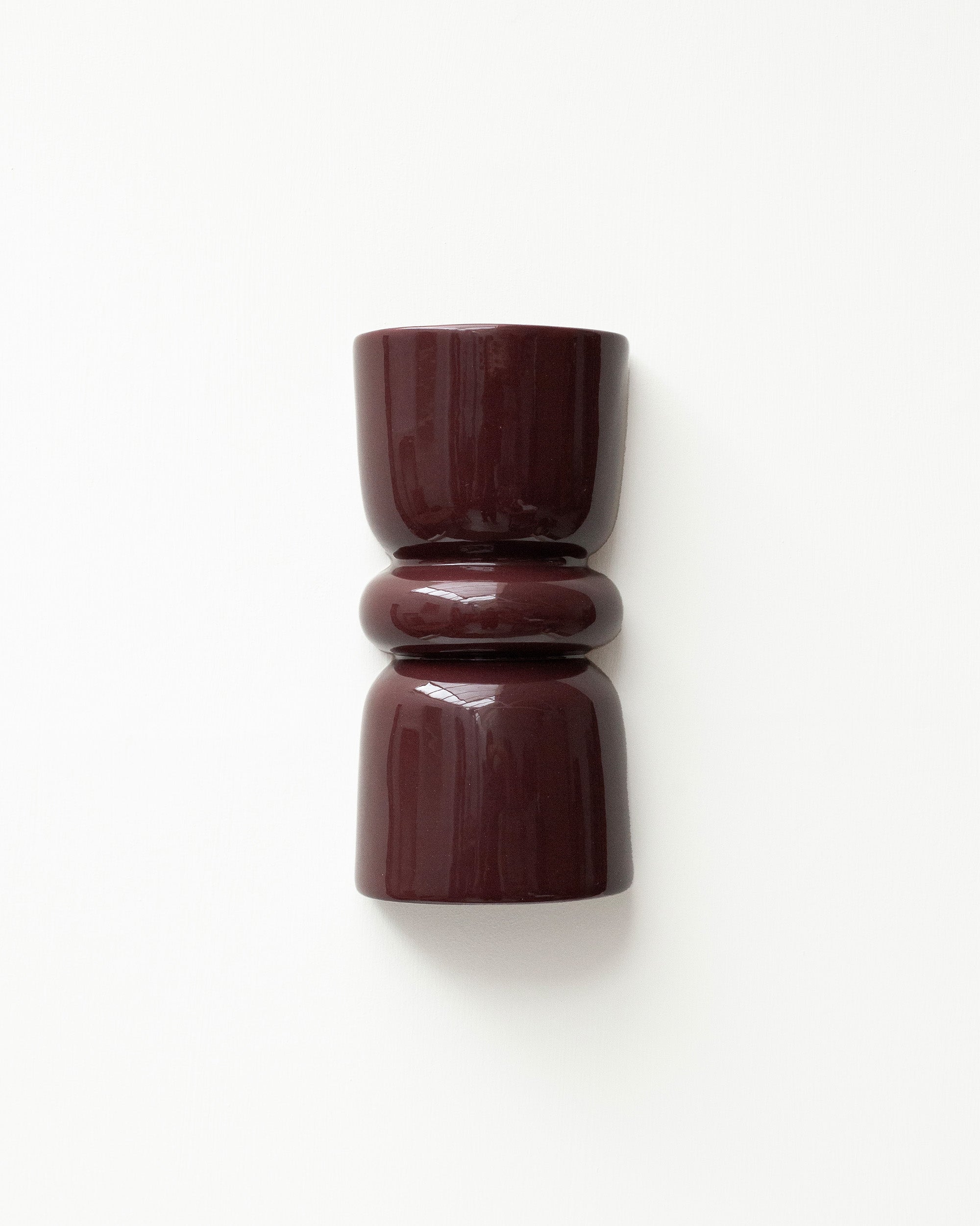 Late Afternoon Lighting Burgundy Up and Down lighter Ceramic Wall Light hung on a white wall