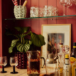 Oro_Jug_and_Blanco_Glasses_on_Shelf