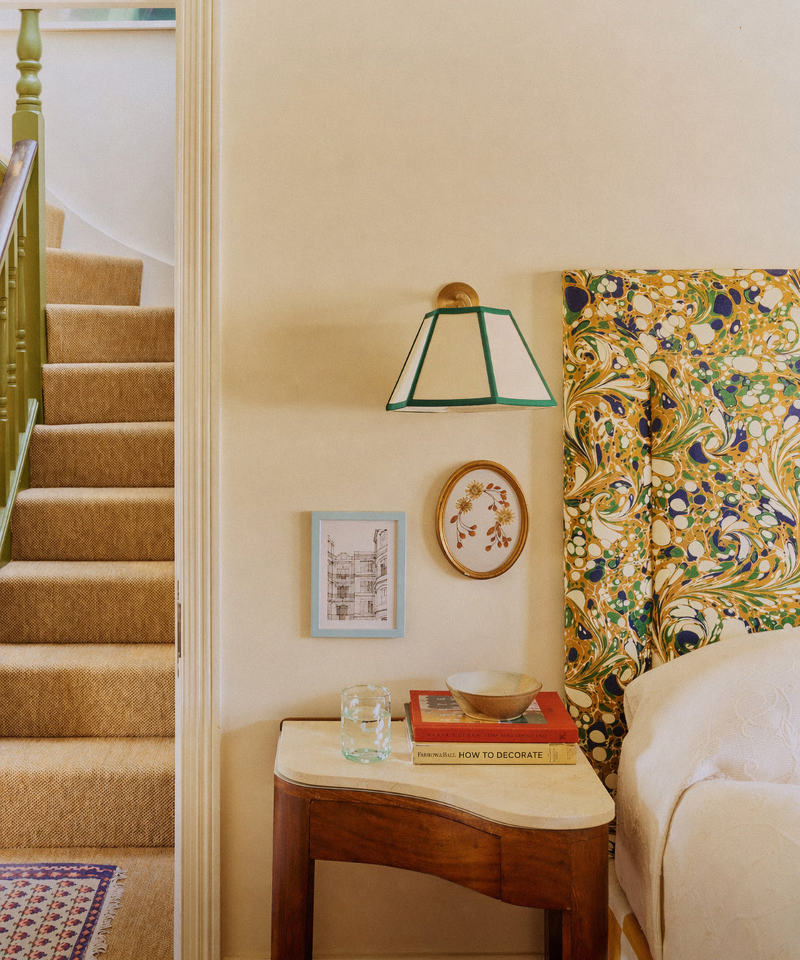 Staircase with a side table, lamp, and decorative items in a home interior.