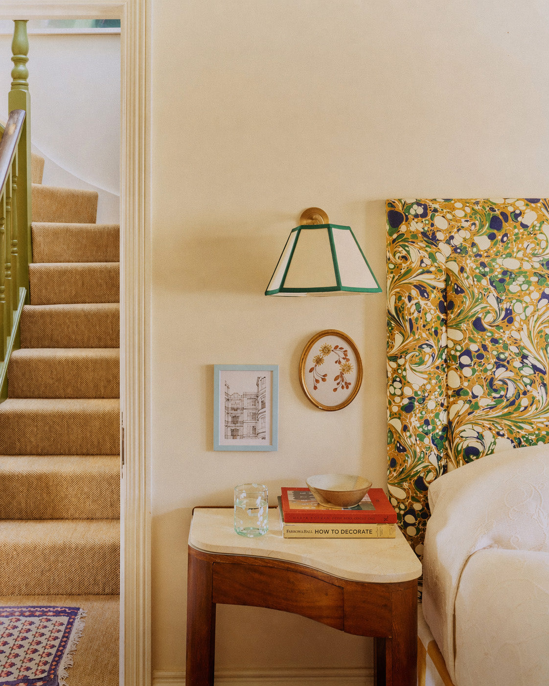 Staircase with a side table, lamp, and decorative items in a home interior.